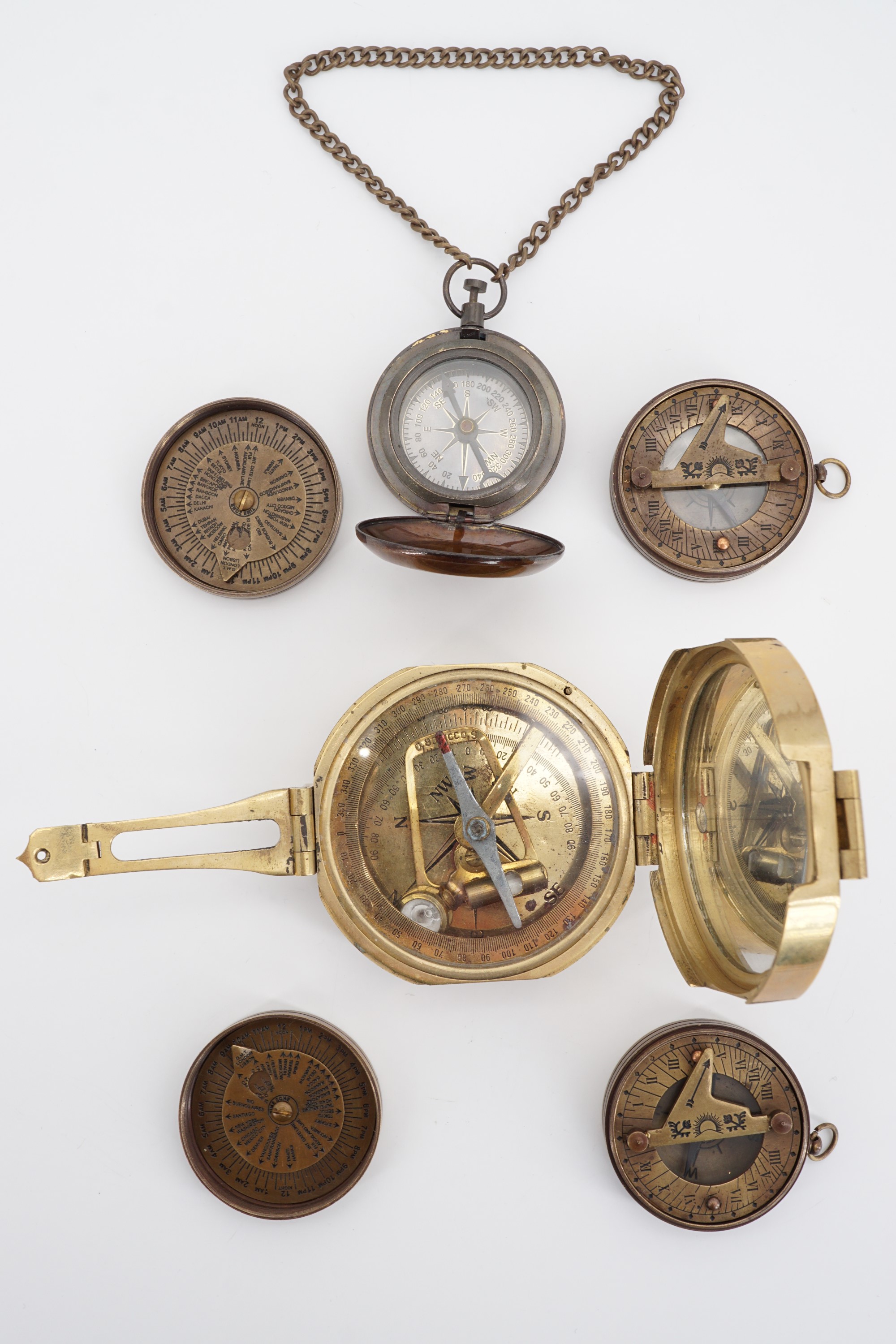 Four various brass compasses / pocket sundials