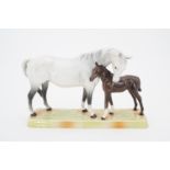 A Beswick figurine of a dappled grey horse and foal, shape number 1811, 16 cm high