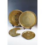 Four various Middle Eastern brass trays, largest 43 cm