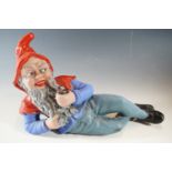 A mid 20th Century painted plaster reclining garden gnome, 31 cm