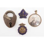 A Victorian brass padlock, locket and badges
