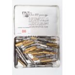 A quantity of dip pen nibs in a Marcovitch printed aluminium cigarettes tin