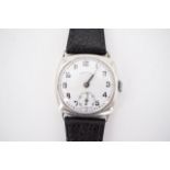 A 1920s Ingersoll silver wrist watch, having a 15 jewel movement and circular white enamel face with