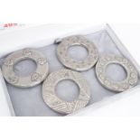 A set of four pewter Celtic style napkin rings, in a Derwent Jewellers of Keswick box