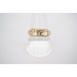 An 18ct gold dress ring with reticulated Greek key design to the face, size R, 3g