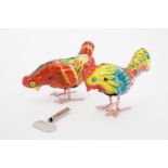 Two tinplate clockwork toy pecking hens