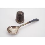 A silver salt spoon and silver thimble