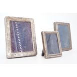 Three silver photograph frames of diminutive size, 11, 10.5 and 7 cm high respectively