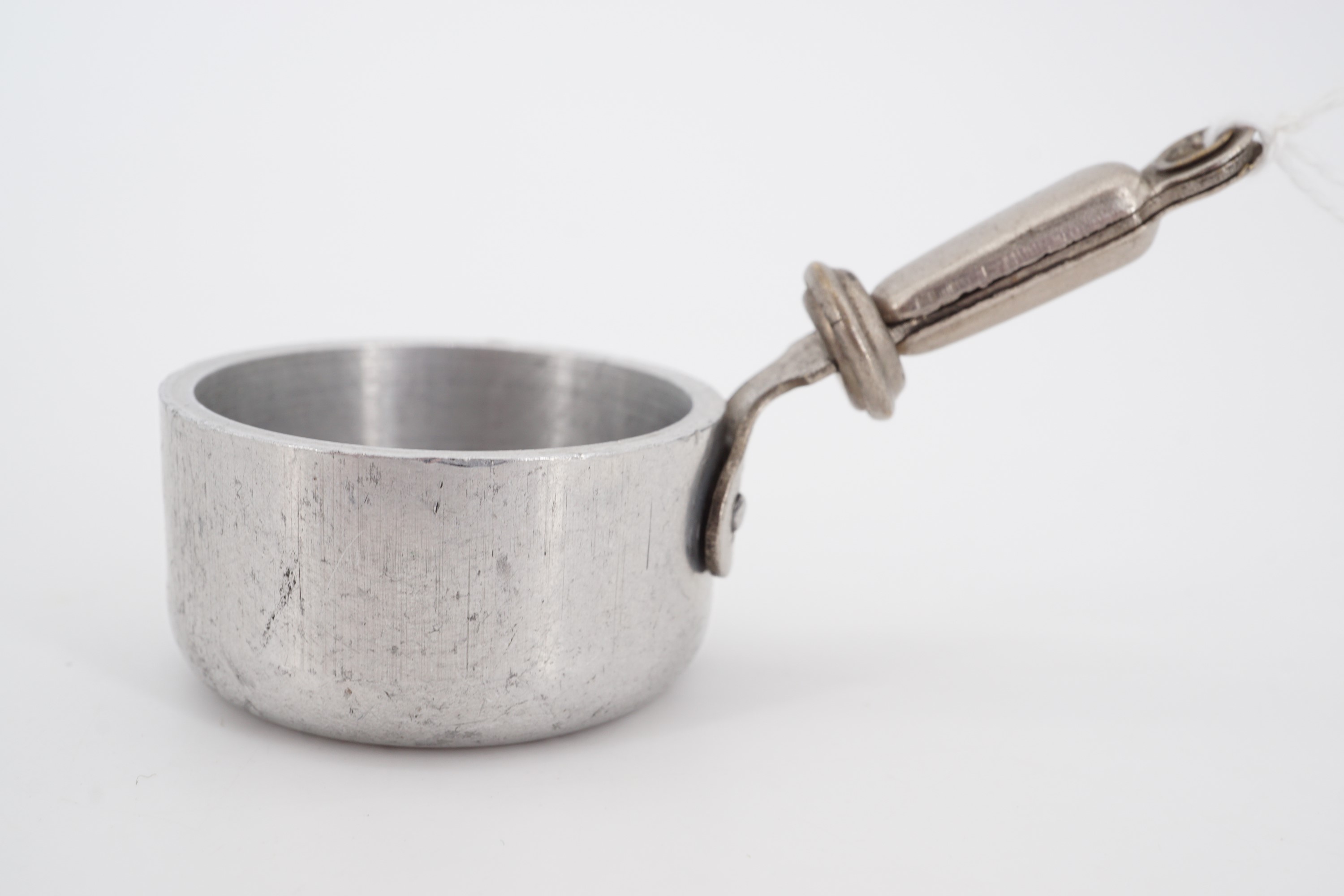 An early 20th Century salesman's miniature sample aluminium cooking pan, 4 cm diameter