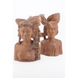Two Balinese carved hardwood busts of young women, 36 cm