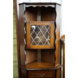 A free standing contemporary carved oak effect corner cabinet, 72 x 44 x 181 cm