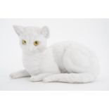 A Victorian glass-eyed Parian ware cat, 14 cm long
