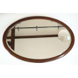 A George V mahogany inlaid oval mirror