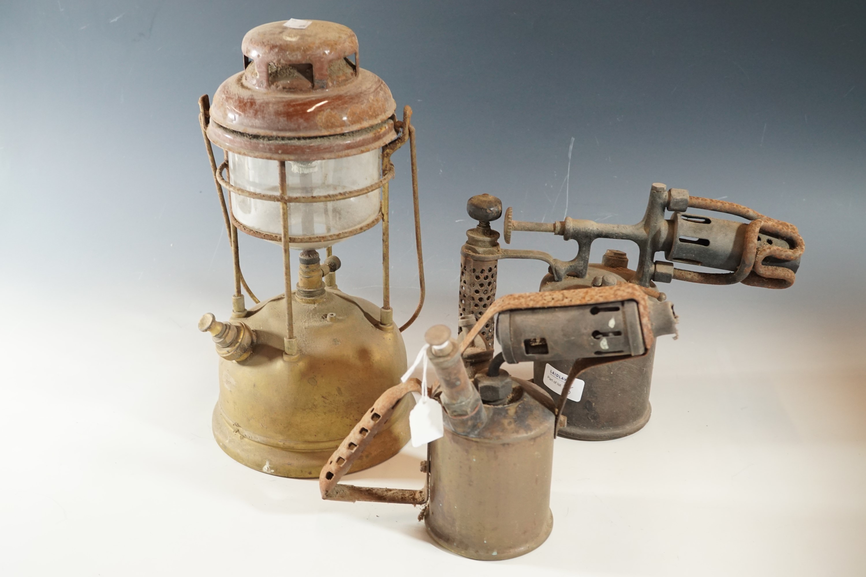 A Tilley lamp and two blow lamps