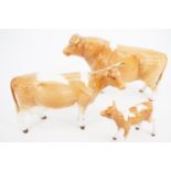 A Beswick Guernsey bull, cow and calf; CH Sabrina's Sir Richmond 14th