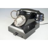 A 1930s black Bakelite telephone