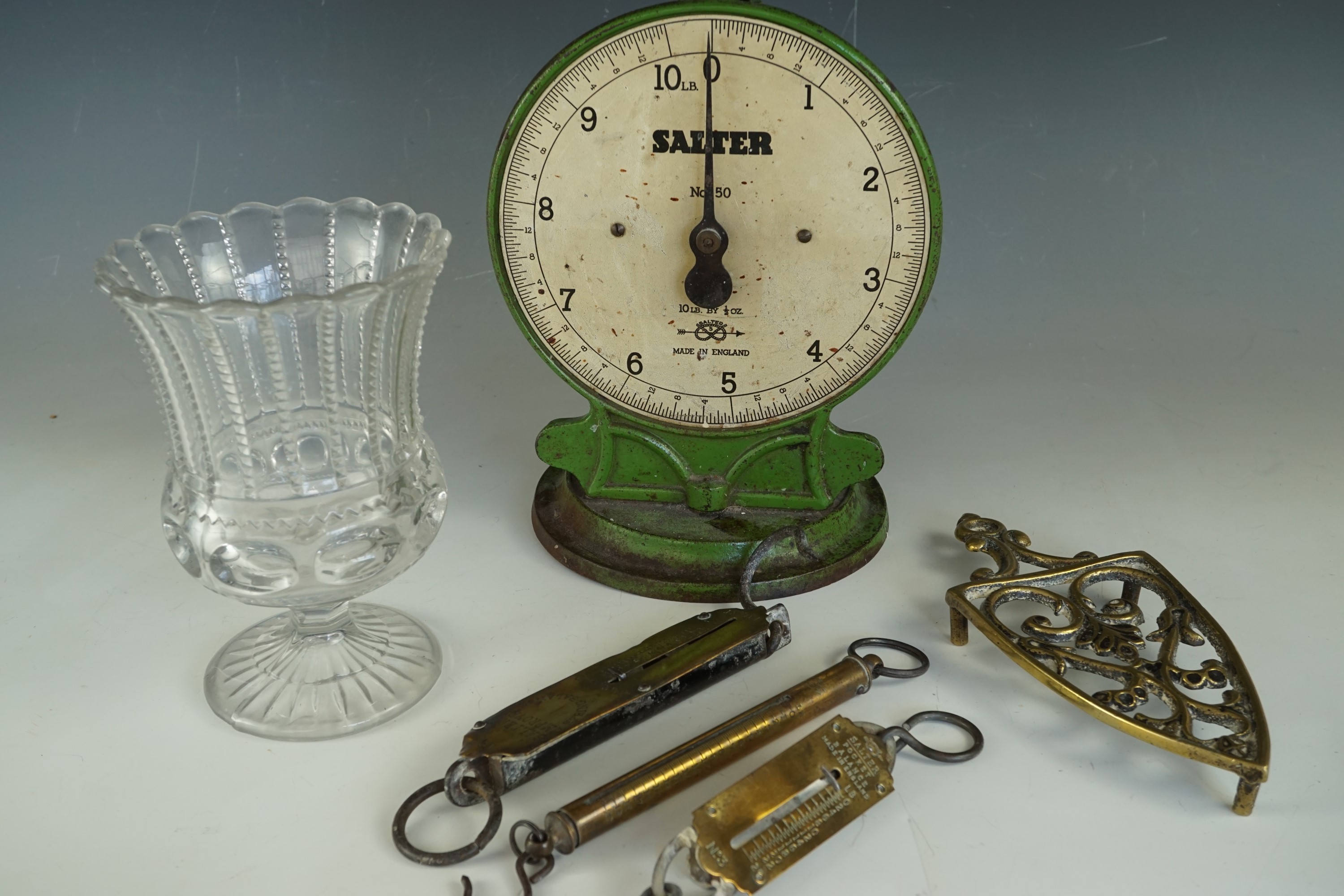 Kitchenalia including Salter No 50 scales, three spring balances, a brass iron stand / trivet and