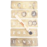 Antique brass alphabet stencils together with a brush