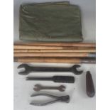 A Wartime military groundsheet, tent pegs and British army issue pincers and other tools