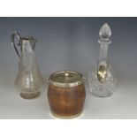 A George V electroplate mounted oak biscuit barrel, a Victorian wheel-cut glass claret jug and a cut