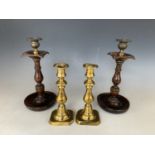 A pair of Victorian brass push-eject candlesticks together with a pair of George V turned oak and