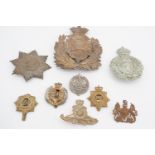 A helmet plate and sundry British military cap badges etc