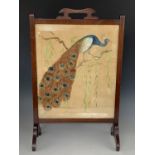 A George V mahogany fire screen with painted fabric peacock insert, 76 cm high