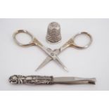 An early 20th Century silver thimble, 1953 Coronation commemorative scissors and tweezers