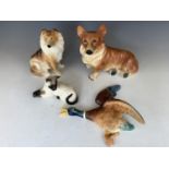 Two Hull Kingston Pottery dogs, a Royal Doulton Siamese cat and a Sylvac mallard wall plaque