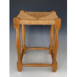 A late 20th century tradition rush-seated turned wooden stool, 34 cm x 33 cm x 46 cm high, [UK P&P