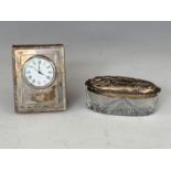 A silver-faced boudoir clock and a silver-lidded cut glass dressing table box
