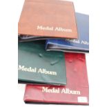 Four ring-binder medal albums and leaves