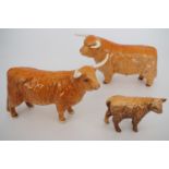 A Beswick Highland bull, cow and calf