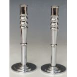 A pair of mid 20th Century moderne chromium plated turned brass candlesticks, 22 cm
