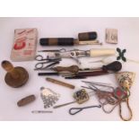 A collection of antique and vintage sewing implements including button hole scissors, a darning