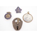A Victorian brass padlock, an Amalgamated Tube Trade Society enamelled lapel badge, another badge