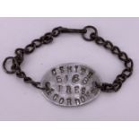 A Great War wrist identity bracelet, stamped "C S Smith, 5168, Pres, 4 Gordons"