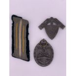 A German Third Reich West Wall medal, Army collar litzen and RAD cap badge