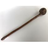 An antique African / Zulu knobkerrie, having an offset head and knotted shaft pierced for a lanyard,