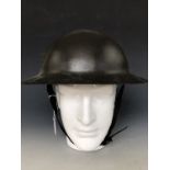 A Great War British army War Office pattern Brodie helmet, retaining its original factory-applied