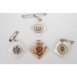 Three Scottish mother-of-pearl sweetheart pendant brooches together with a Royal Engineers example