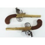 A pair of brass cannon barrelled flintlock pistols by J & W Richards, each having tapering approx