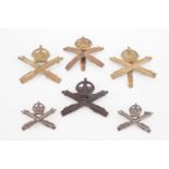 Machine Gun Corps badges including a pair of white metal collar badges