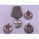 A Soviet Medal for Combat Service together with three Medals for Valiant Labour