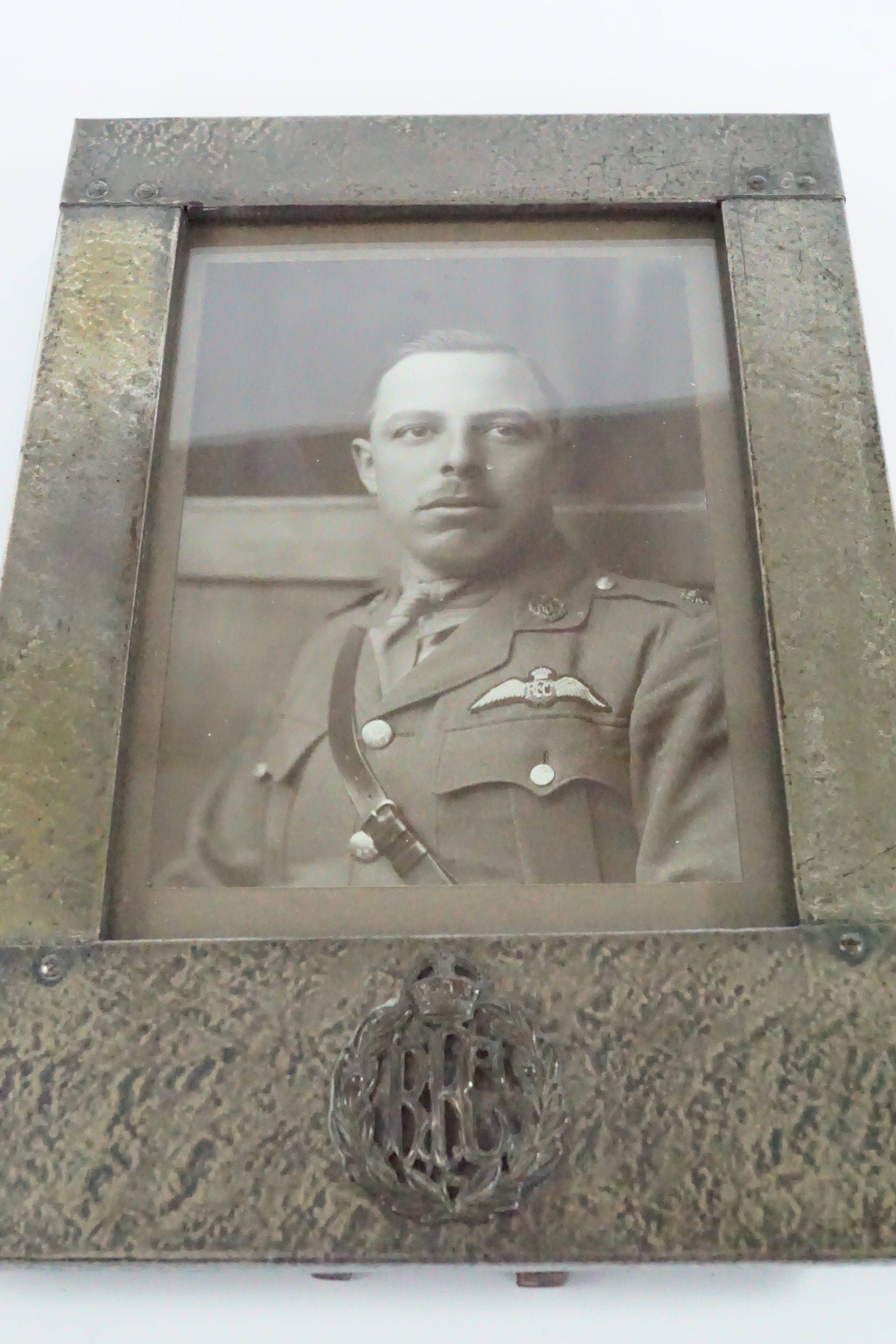 A Great War Arts and Crafts influenced electroplate photograph frame bearing an applied Royal Flying