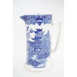 A Burleigh Ware willow pattern pewter lidded jug, 19cm