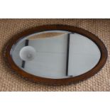 A George V oak oval wall mirror, 78 cm x 50 cm