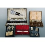 A cased dessert set, cased teaspoons and sugar nips etc.