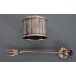 An Edwardian silver pickle fork, the terminal modelled as a thistle and set with an amethyst