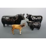 A Beswick Aberdeen Angus bull and cow together with an Aberdeen Angus decanter, and a Beswick calf